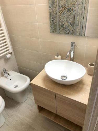 a bathroom with a sink and a toilet at I MORI - Holiday Rooms in Lascari