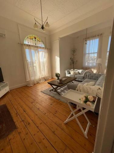 a living room with a couch and a table at The Grayce Place. in Warrnambool