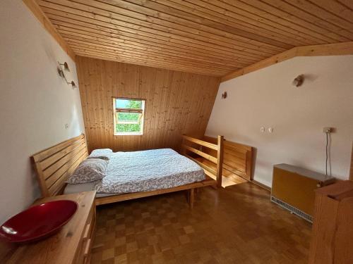 a bedroom with a bed in a wooden room at BovecApartmentA in Bovec