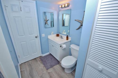 Un baño con un inodoro blanco y un lavabo. en Oceania Plaza 502, en New Smyrna Beach