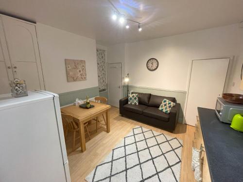 a living room with a couch and a table at Self-Contained Ground Floor Flat in Nottingham