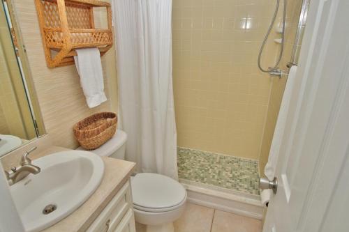 a bathroom with a sink and a toilet and a shower at Ocean Club North C208 in New Smyrna Beach