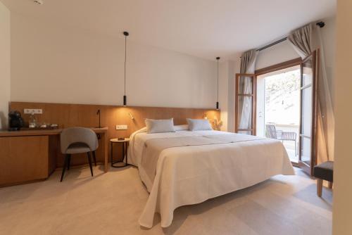a bedroom with a large white bed and a window at Nema Boutique Hotel & Spa in Artá