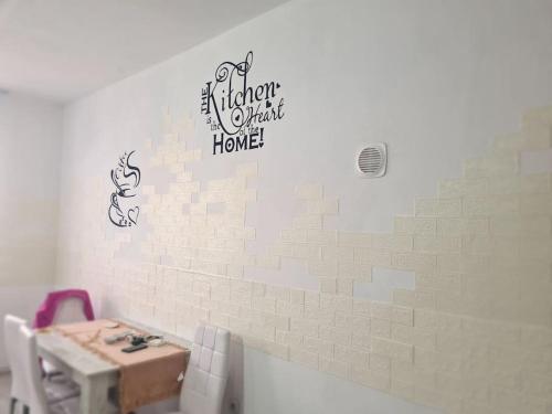 a bathroom with a table and a sign on a wall at Mural Art Apartament in Petroşani