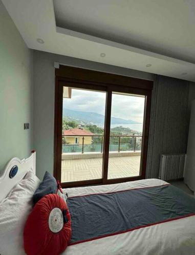 a bedroom with a bed and a large window at The Luxe Esenköy Villa in Yalova