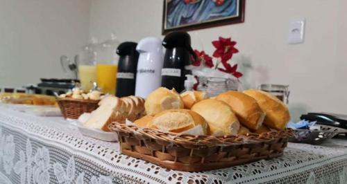 a table with baskets of bread on a table at Hotel Montana Aeroporto by Bsb Inn in Brasilia