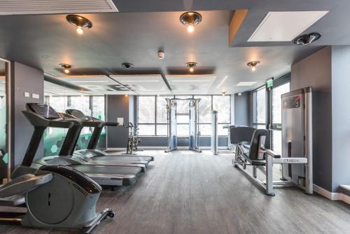 a gym with treadmills and machines in a room at For Students Only - Queen's Court Reading in Reading