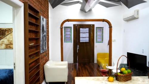 uma sala de estar com uma mesa e uma televisão em Casinha em Porto Alegre