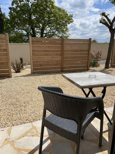 a patio with a table and a table and a chair at Hôtel Le Mas del Pechs - Chambres avec terrasse in Sarlat-la-Canéda