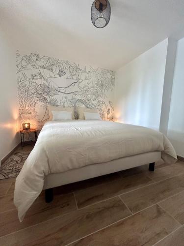 a bedroom with a bed with a mural on the wall at Gite de La Rastelle au coeur de la nature in Savignac-de-Duras