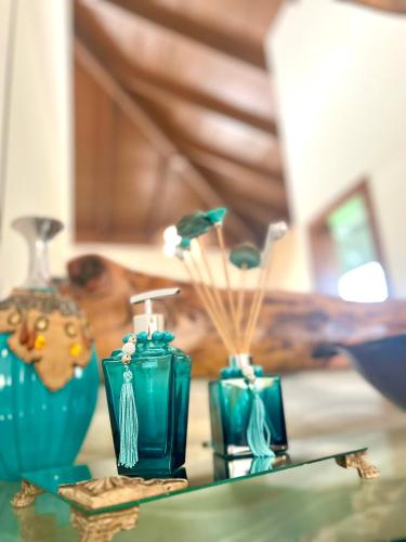 a group of blue vases sitting on a table at Lara's Home Suites in Capitólio