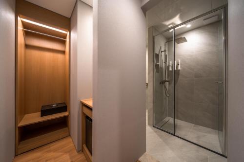 a walk in shower in a bathroom with a glass door at Comfort inn Yeouido in Seoul