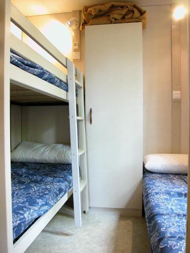 a bunk bed room with two bunk beds and a closet at Camping El Balcon de Pitres in Pitres