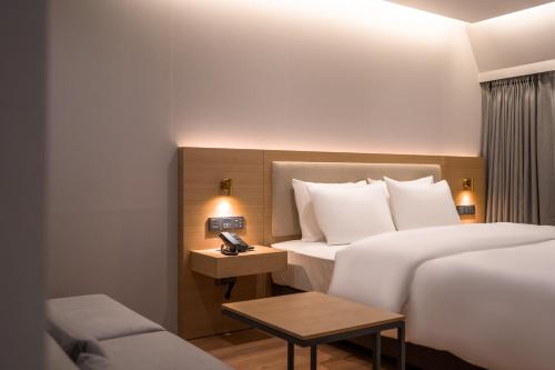 a hotel room with two beds and a telephone at Comfort inn Yeouido in Seoul
