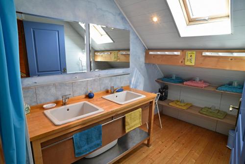 a bathroom with two sinks and a mirror at Gite Le Douglas, Vignoble et Reculées du Jura - Avec Sauna in Lavigny
