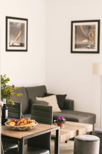 a living room with a table with fruit on it at Grey House in Chorafakia