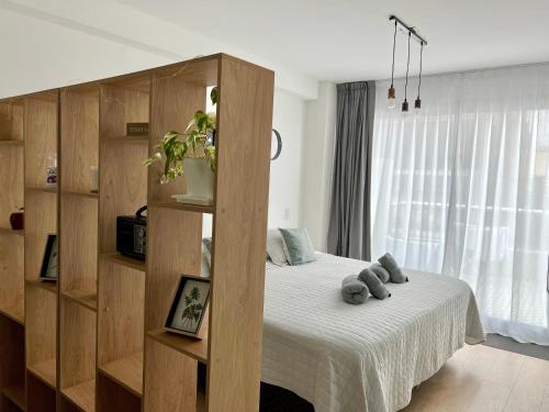 1 dormitorio con cama y estante para libros en GASCON y DIAZ VELEZ en Buenos Aires