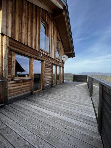 a wooden deck on the side of a house at Höhenchalet Klippitz in Bad Sankt Leonhard im Lavanttal