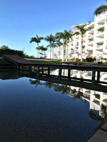 a bridge over a body of water in front of a building at De las mejores vistas del Condominio in Nuevo Vallarta 