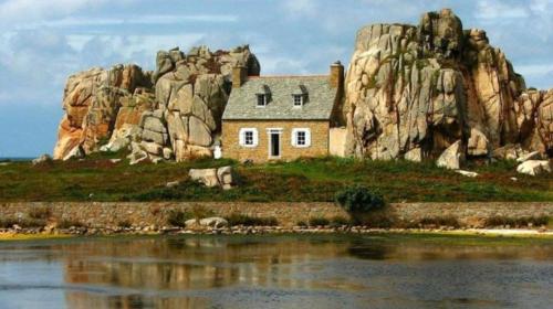 a house on an island in front of a mountain at Les Portes de Tréguier - Gites de charme in Tréguier