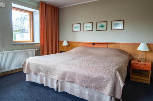a hotel room with a bed and a window at Tähetorni Hotel in Tallinn