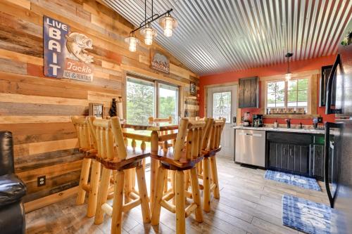 a dining room with a table and chairs at Lakeside Cabin with Fire Pit Near Pine Point Park! in Holcombe