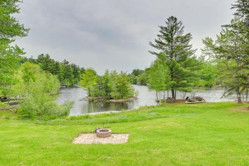 a view of a river with a field of grass at Lakeside Cabin with Fire Pit Near Pine Point Park! in Holcombe