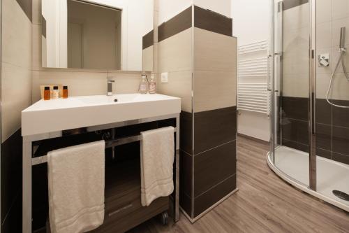 y baño con lavabo y ducha. en Appartamenti Le Perle di Venere, en Marina di Grosseto