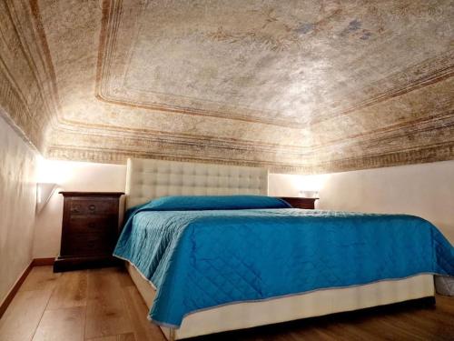 une chambre avec un lit bleu et un plafond dans l'établissement Elegante appartamento in centro., à Turin