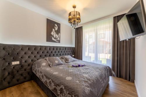 Ένα ή περισσότερα κρεβάτια σε δωμάτιο στο Sunrise Apartaments Luxury