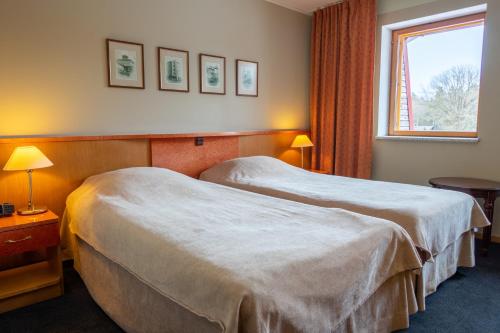 מיטה או מיטות בחדר ב-Tähetorni Hotel