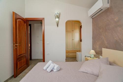 Postel nebo postele na pokoji v ubytování Rooms Tavolara