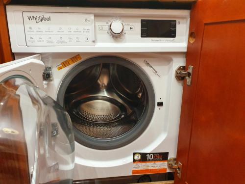 a washing machine in a kitchen with its door open at 1-комнатная квартира ВИП уровня посуточно в Ужгороде. ул.И.Франка. in Uzhhorod