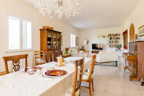 ein Esszimmer und ein Wohnzimmer mit einem Tisch und Stühlen in der Unterkunft Villa La Serenata di Pietro in Taranto