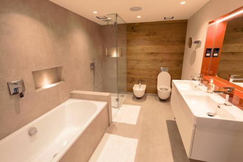 a bathroom with two sinks and a tub and a toilet at The Royal Suite- Harbour Views- Ramsgate in Kent