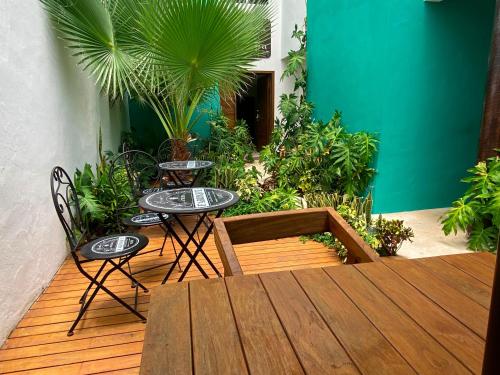 a patio with two tables and chairs and plants at Villa Sofia Boutique Hotel - Near Cancun Downtown - Free Cancellation in Cancún