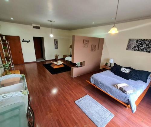 een slaapkamer met een bed en een woonkamer bij Acogedora casa en Chihuahua Capital in Chihuahua