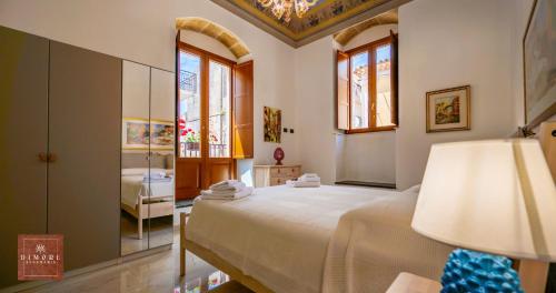 a bedroom with a large bed and a mirror at Dimore Anna Maria -Casa Liberty- in Avola