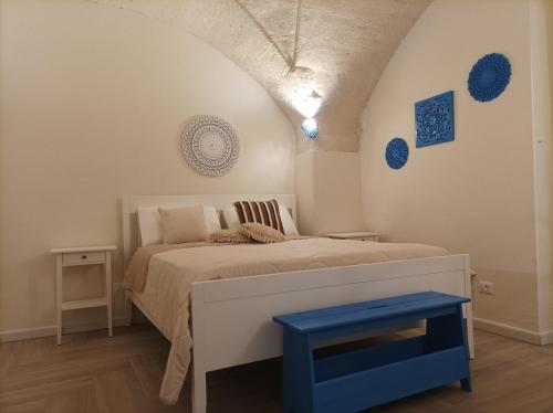 1 dormitorio con 1 cama con taburete azul en Casa KaLu', en Crispiano