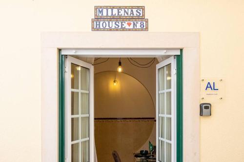 a door to a house with a sign above it at Milena's House in Nazaré