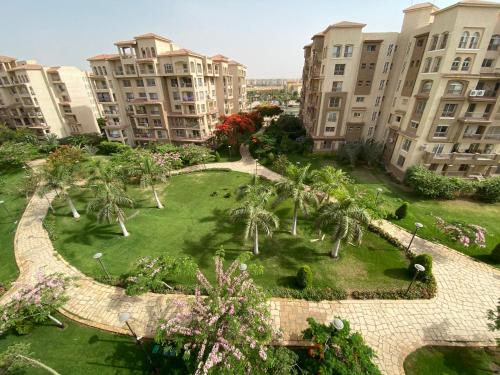 an aerial view of a park with palm trees and buildings at Luxury Inn 3BR Amazing view in Madinaty B2 in Madinaty