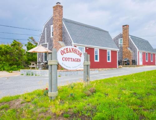 a sign in the grass in front of a building at Sand, Sun Serenity: Cape Cod Escape in East Sandwich