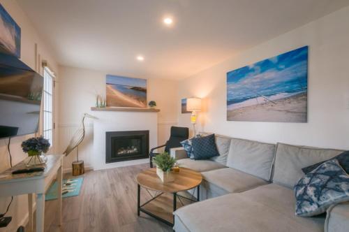 a living room with a couch and a fireplace at Sand, Sun Serenity: Cape Cod Escape in East Sandwich