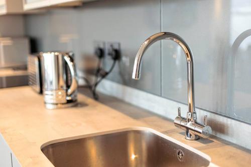 a kitchen counter with a stainless steel sink at SoHot Stays Harbourside Suite 2nd Floor Sleeps 4 in Kent