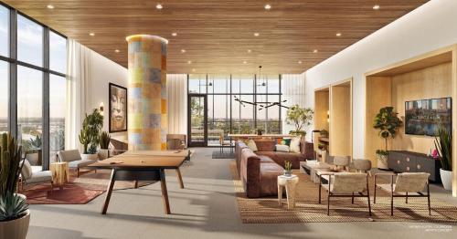 a lobby with a couch and tables and chairs at 2BD Condo-Rainey St-Best views-RT Pool in Austin