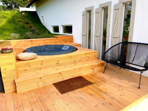 a wooden deck with a dog bed on a house at Bohemian Eco Lodge at lake Balaton in Kisapáti