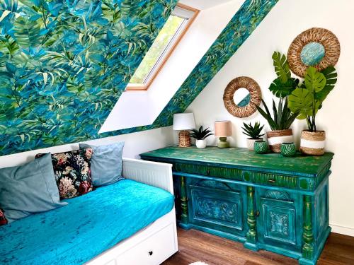 a room with a blue bench with plants on it at Bohemian Eco Lodge at lake Balaton in Kisapáti