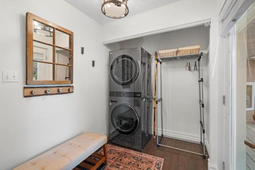 a laundry room with a washing machine next to a door at Le Champetre Tremblant 2bdrs Condo W Fireplace in Mont-Tremblant