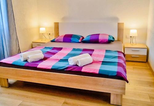 a bedroom with a large bed with two pillows at Tora in Mali Lošinj
