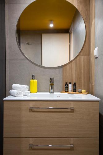 a bathroom with a sink and a mirror at The Frogs_Guest House in Athens